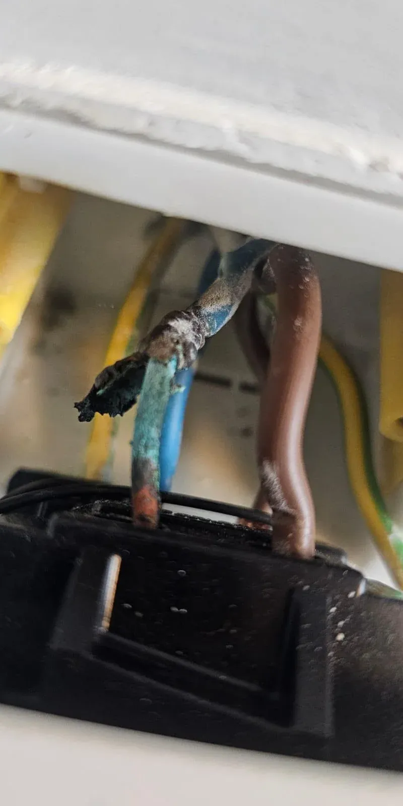 Electrician using a Megger meter for electrical fault finding
